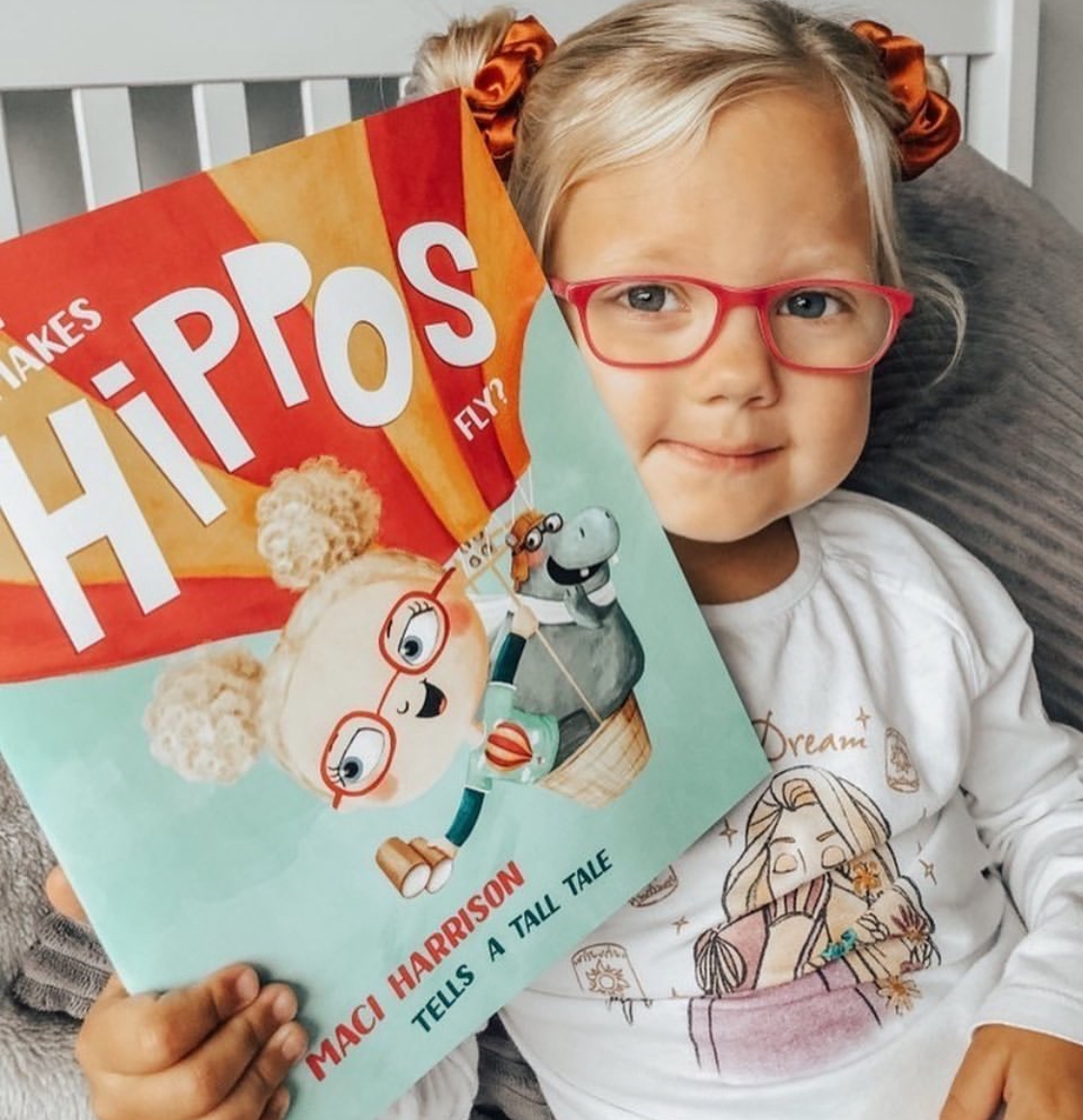 A child with a personalised Petite Giants book